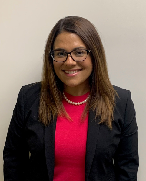 headshot of melissa del valle.  female with red shirt, suit jacket, glasses